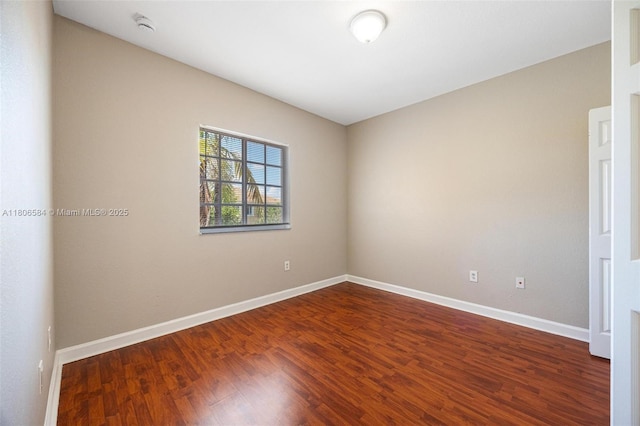 1985 SE 3rd St, Homestead, FL 33033 - unfurnished room with dark wood-type flooring, baseboards, and a smoke detector