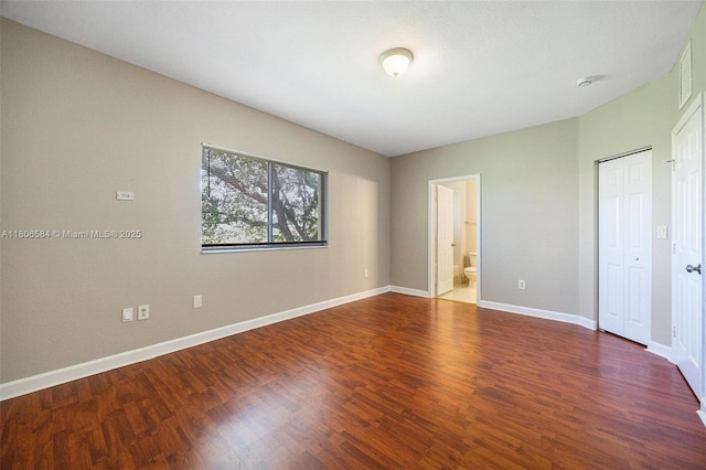 1985 SE 3rd St, Homestead, FL 33033 - unfurnished bedroom with wood finished floors, baseboards, connected bathroom, and a closet