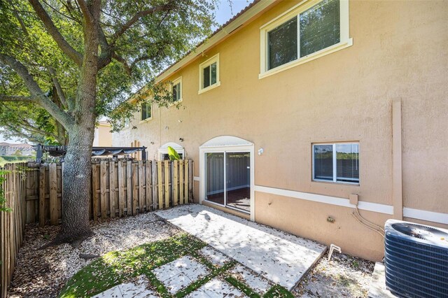 1985 SE 3rd St, Homestead, FL 33033 - rear view of house featuring central AC unit, a patio, and stucco siding
