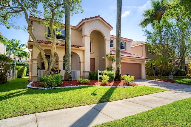 850 Nandina Dr, Weston, FL 33327 - mediterranean / spanish-style home with driveway, stucco siding, a front lawn, and a tiled roof