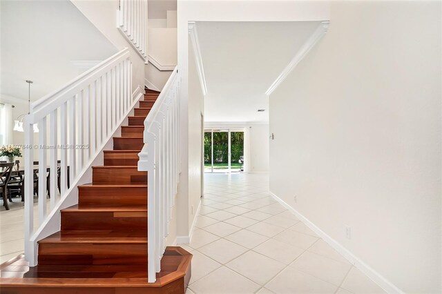850 Nandina Dr, Weston, FL 33327 - stairs featuring tile patterned floors, crown molding, and baseboards
