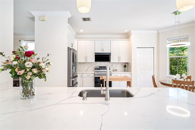 850 Nandina Dr, Weston, FL 33327 - kitchen with appliances with stainless steel finishes, range hood, a sink, white cabinetry, and ornamental molding