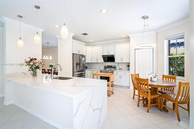 850 Nandina Dr, Weston, FL 33327 - kitchen featuring stainless steel appliances, a sink, a peninsula, ornamental molding, and decorative backsplash