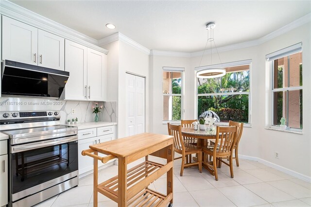 850 Nandina Dr, Weston, FL 33327 - kitchen featuring stainless steel electric range oven, light countertops, decorative backsplash, baseboards, and white cabinets