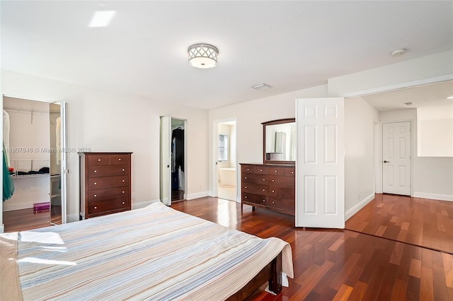 850 Nandina Dr, Weston, FL 33327 - bedroom with a walk in closet, wood finished floors, baseboards, a closet, and ensuite bath