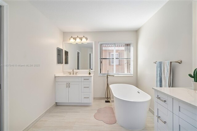850 Nandina Dr, Weston, FL 33327 - bathroom with baseboards, vanity, and a freestanding bath