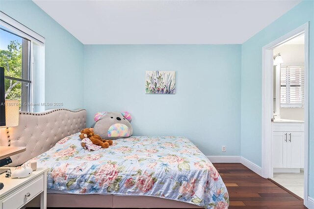 850 Nandina Dr, Weston, FL 33327 - bedroom with wood finished floors, baseboards, and ensuite bathroom