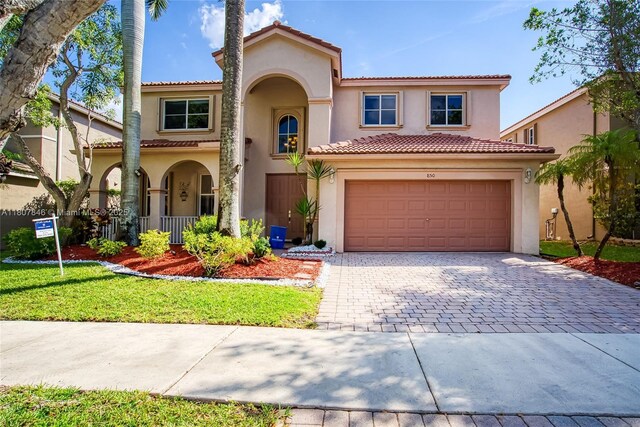 850 Nandina Dr, Weston, FL 33327 - mediterranean / spanish-style house featuring stucco siding, decorative driveway, and a tile roof