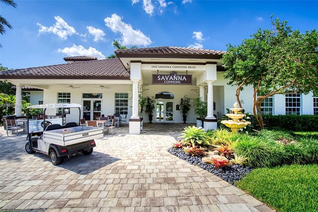 850 Nandina Dr, Weston, FL 33327 - rear view of house featuring french doors, a tiled roof, stucco siding, and a ceiling fan