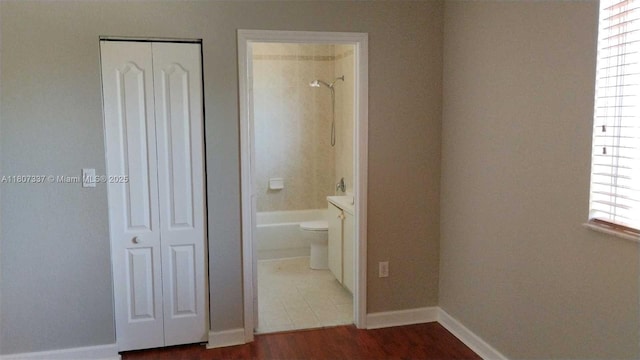 21485 SW 85th Path, Cutler Bay, FL 33189 - unfurnished bedroom with a closet, connected bathroom, wood finished floors, and baseboards