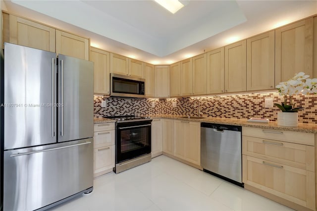 3500 Coral Way Unit 604, Miami, FL 33145 - kitchen featuring stainless steel appliances, light brown cabinetry, a sink, light tile patterned floors, and tasteful backsplash