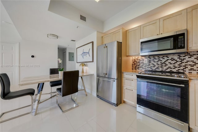 3500 Coral Way Unit 604, Miami, FL 33145 - kitchen featuring stainless steel appliances, light brown cabinetry, tasteful backsplash, and light tile patterned flooring