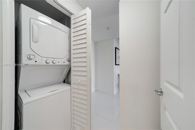 3500 Coral Way Unit 604, Miami, FL 33145 - laundry room with stacked washing machine and dryer and tile patterned floors
