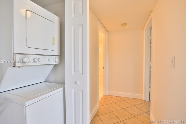 3000 Coral Way Unit 1505, Miami, FL 33145 - washroom with stacked washer / drying machine, light tile patterned floors, and baseboards