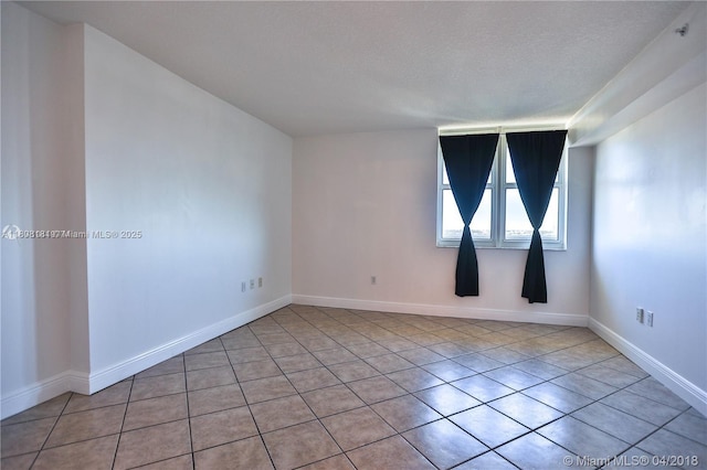 3000 Coral Way Unit 1505, Miami, FL 33145 - spare room featuring tile patterned floors, a textured ceiling, and baseboards