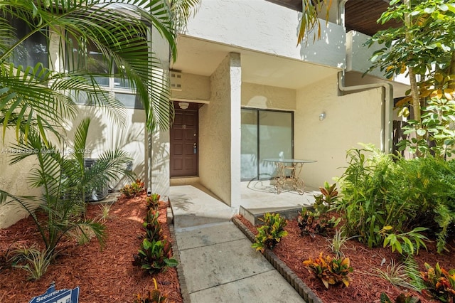 19460 NE 26th Ave Unit 12B, Miami, FL 33180 - view of exterior entry featuring stucco siding and a porch