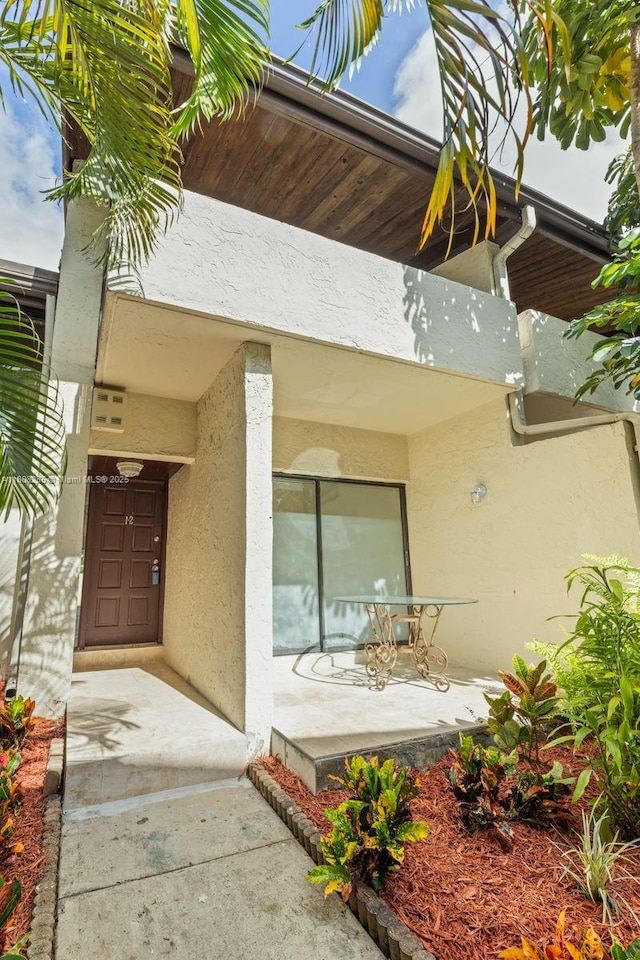 19460 NE 26th Ave Unit 12B, Miami, FL 33180 - entrance to property with stucco siding and a porch