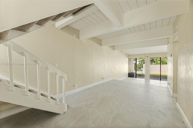 19460 NE 26th Ave Unit 12B, Miami, FL 33180 - unfurnished room with baseboards, a textured wall, wooden ceiling with exposed beams, and stairway