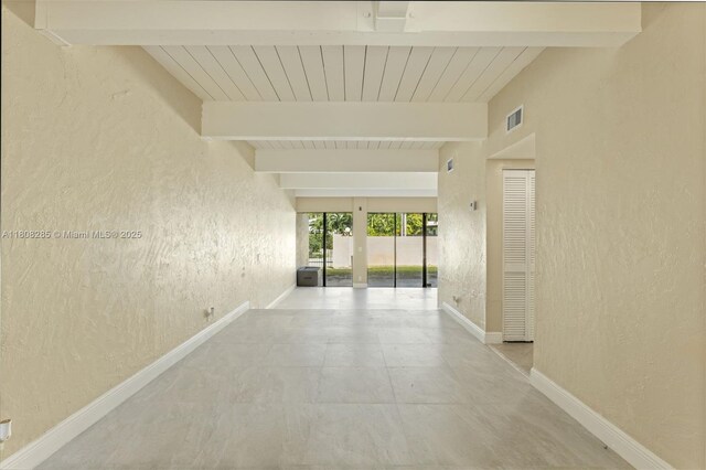 19460 NE 26th Ave Unit 12B, Miami, FL 33180 - hall with a textured wall, beam ceiling, and baseboards