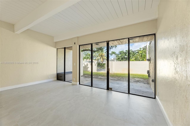 19460 NE 26th Ave Unit 12B, Miami, FL 33180 - spare room with wooden ceiling with exposed beams, baseboards, and a textured wall
