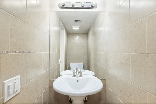 19460 NE 26th Ave Unit 12B, Miami, FL 33180 - bathroom with tile walls and a sink