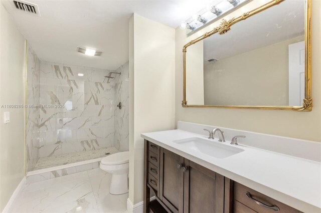 19460 NE 26th Ave Unit 12B, Miami, FL 33180 - full bathroom with marble look tile flooring, toilet, vanity, a marble finish shower, and baseboards
