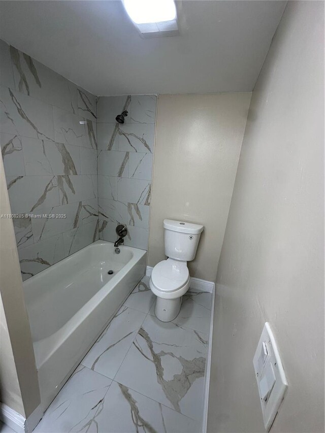 19460 NE 26th Ave Unit 12B, Miami, FL 33180 - bathroom with marble look tile flooring, toilet, and  shower combination
