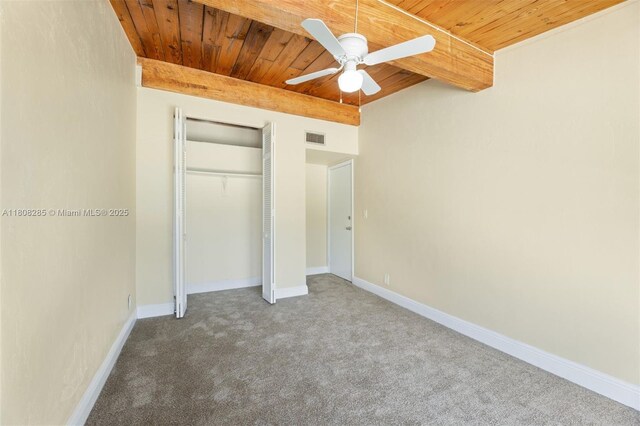 19460 NE 26th Ave Unit 12B, Miami, FL 33180 - unfurnished bedroom featuring wooden ceiling with exposed beams, carpet, a closet, baseboards, and ceiling fan