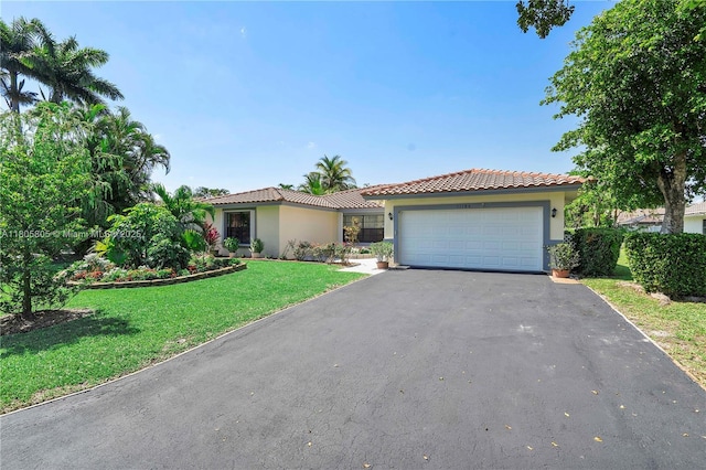 11186 NW 21st St, Coral Springs, FL 33071 - mediterranean / spanish house featuring asphalt driveway, stucco siding, a front yard, a garage, and a tiled roof