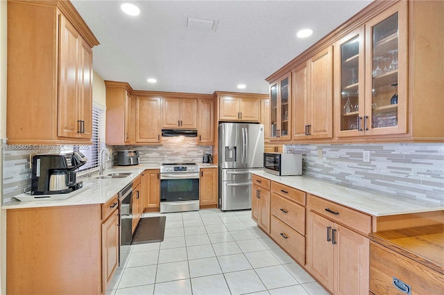 11186 NW 21st St, Coral Springs, FL 33071 - kitchen with stainless steel appliances, a sink, light tile patterned flooring, decorative backsplash, and recessed lighting