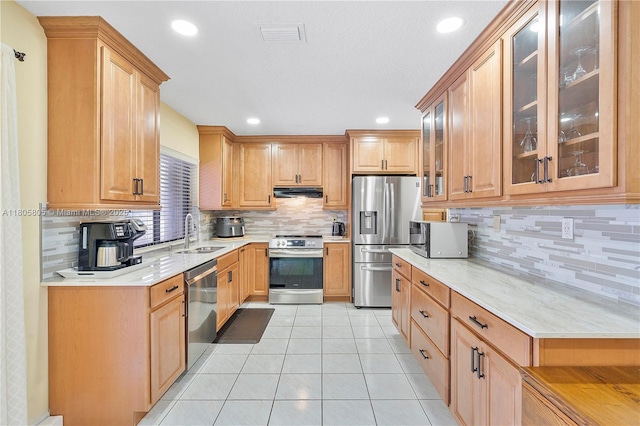 11186 NW 21st St, Coral Springs, FL 33071 - kitchen with appliances with stainless steel finishes, a sink, under cabinet range hood, decorative backsplash, and light countertops