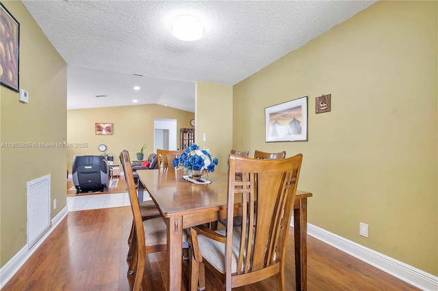 11186 NW 21st St, Coral Springs, FL 33071 - dining space featuring wood finished floors, baseboards, a textured ceiling, and lofted ceiling