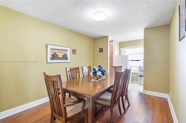 11186 NW 21st St, Coral Springs, FL 33071 - dining space with wood finished floors, a textured ceiling, and baseboards