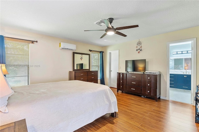 11186 NW 21st St, Coral Springs, FL 33071 - bedroom with an AC wall unit, wood finished floors, multiple windows, a ceiling fan, and a textured ceiling
