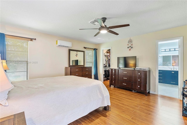 11186 NW 21st St, Coral Springs, FL 33071 - bedroom featuring a spacious closet, light wood-style floors, a wall mounted AC, a closet, and ensuite bathroom