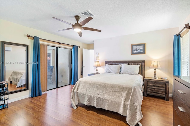 11186 NW 21st St, Coral Springs, FL 33071 - bedroom featuring wood finished floors, multiple windows, access to outside, a textured ceiling, and ceiling fan