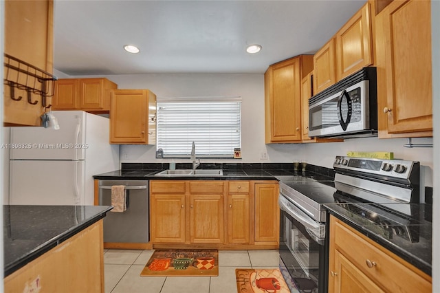 1551 NW 92nd Ave Unit 185, Pembroke Pines, FL 33024 - kitchen featuring appliances with stainless steel finishes, a sink, dark countertops, light tile patterned flooring, and recessed lighting