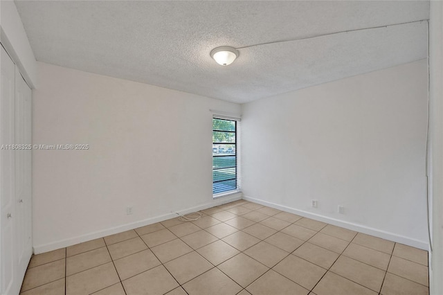 1551 NW 92nd Ave Unit 185, Pembroke Pines, FL 33024 - unfurnished room featuring a textured ceiling, baseboards, and light tile patterned floors