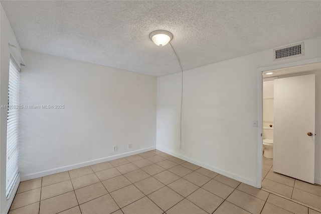 1551 NW 92nd Ave Unit 185, Pembroke Pines, FL 33024 - spare room featuring light tile patterned flooring, a textured ceiling, and baseboards