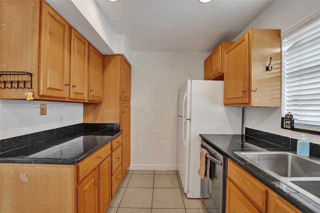 1551 NW 92nd Ave Unit 185, Pembroke Pines, FL 33024 - kitchen featuring dishwasher, dark countertops, light tile patterned floors, and baseboards