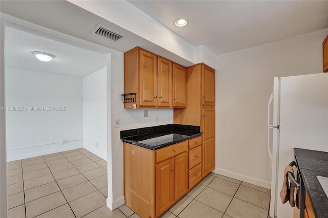 1551 NW 92nd Ave Unit 185, Pembroke Pines, FL 33024 - kitchen with light tile patterned floors, freestanding refrigerator, recessed lighting, and baseboards