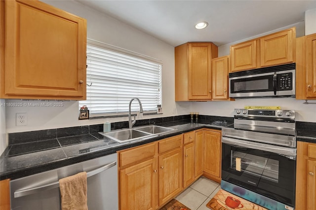1551 NW 92nd Ave Unit 185, Pembroke Pines, FL 33024 - kitchen featuring appliances with stainless steel finishes, a sink, dark countertops, light tile patterned floors, and recessed lighting