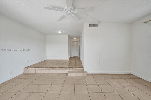 1551 NW 92nd Ave Unit 185, Pembroke Pines, FL 33024 - spare room with light tile patterned floors, a ceiling fan, and a textured ceiling