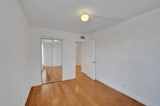 1551 NW 92nd Ave Unit 185, Pembroke Pines, FL 33024 - unfurnished bedroom with light wood-style flooring, a closet, and baseboards