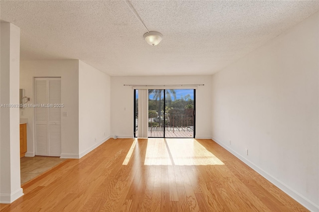 1551 NW 92nd Ave Unit 185, Pembroke Pines, FL 33024 - unfurnished room with wood finished floors, a textured ceiling, and baseboards