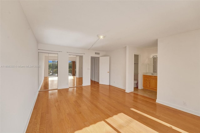 1551 NW 92nd Ave Unit 185, Pembroke Pines, FL 33024 - spare room featuring light wood-style flooring and baseboards