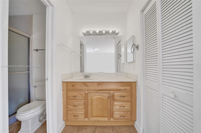 1551 NW 92nd Ave Unit 185, Pembroke Pines, FL 33024 - full bath featuring a closet, toilet, vanity, tile patterned flooring, and a shower with shower door