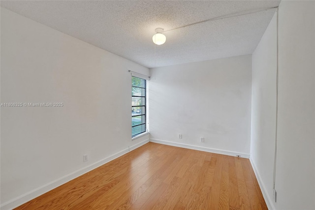 1551 NW 92nd Ave Unit 185, Pembroke Pines, FL 33024 - empty room featuring light wood-style floors, a textured ceiling, and baseboards