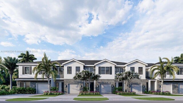 147 NE 13th Ter, Homestead, FL 33033 - townhome / multi-family property featuring an attached garage, driveway, and stucco siding