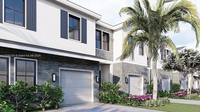 147 NE 13th Ter, Homestead, FL 33033 - view of front of house with a garage, stone siding, stucco siding, and driveway